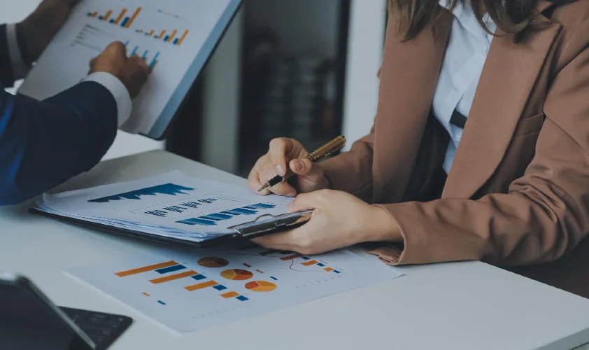 Business people working together in meeting room charts and graphs banner double exposure successful teamwork business planning concept