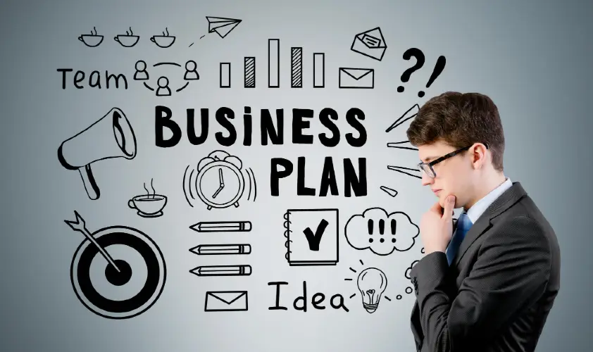 Side view of businessman in glasses near a business plan sketch